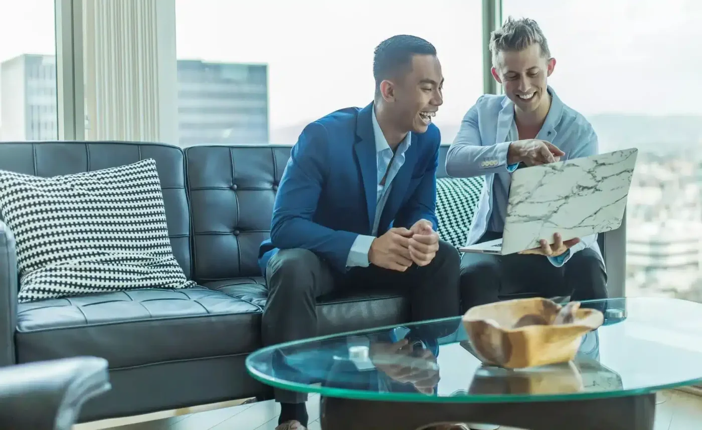business men on couch with laptop